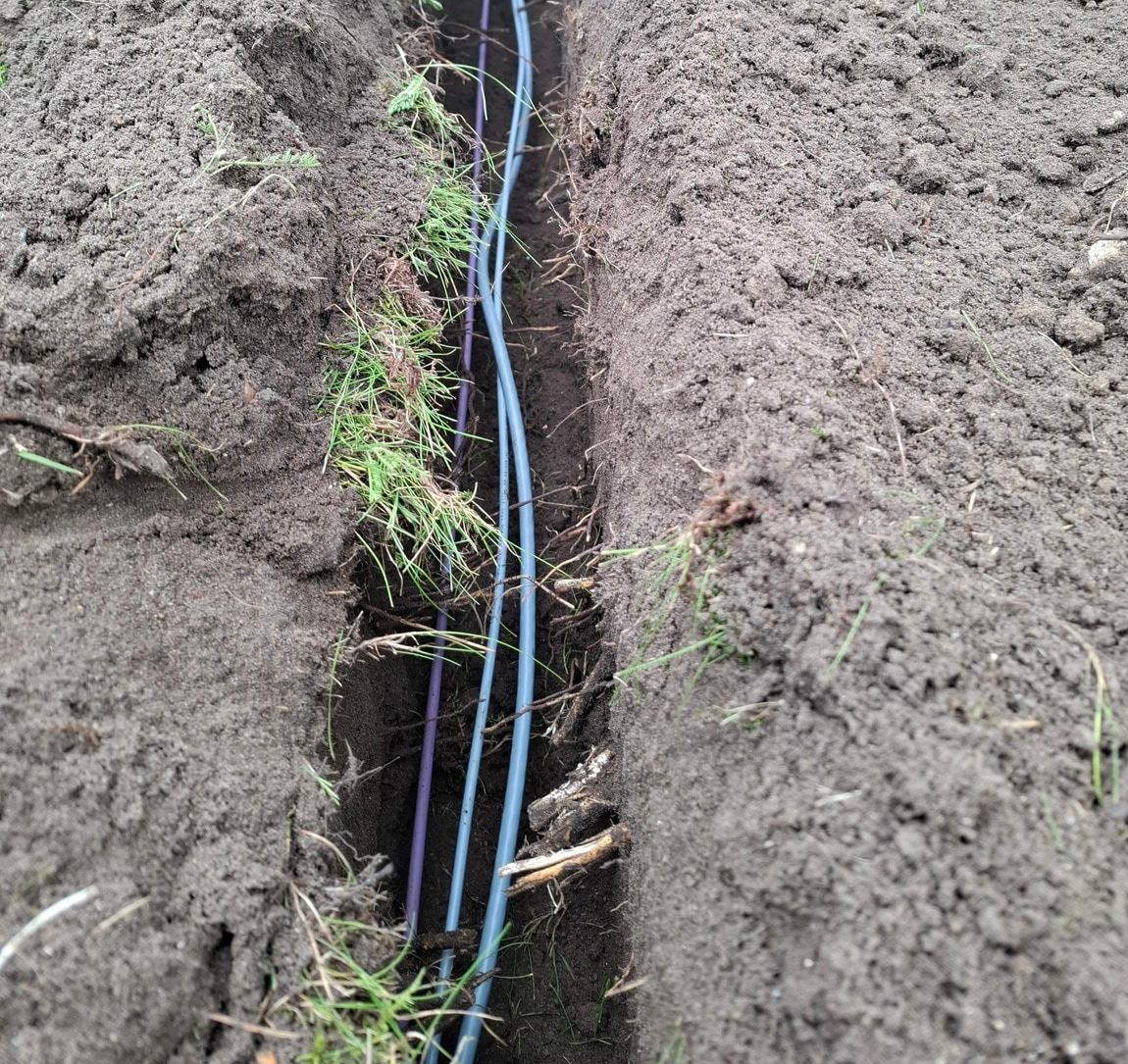 irrigation pipes and signal cables laid in the same trench