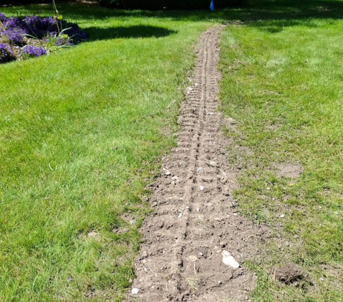 backfilled trench in lawn