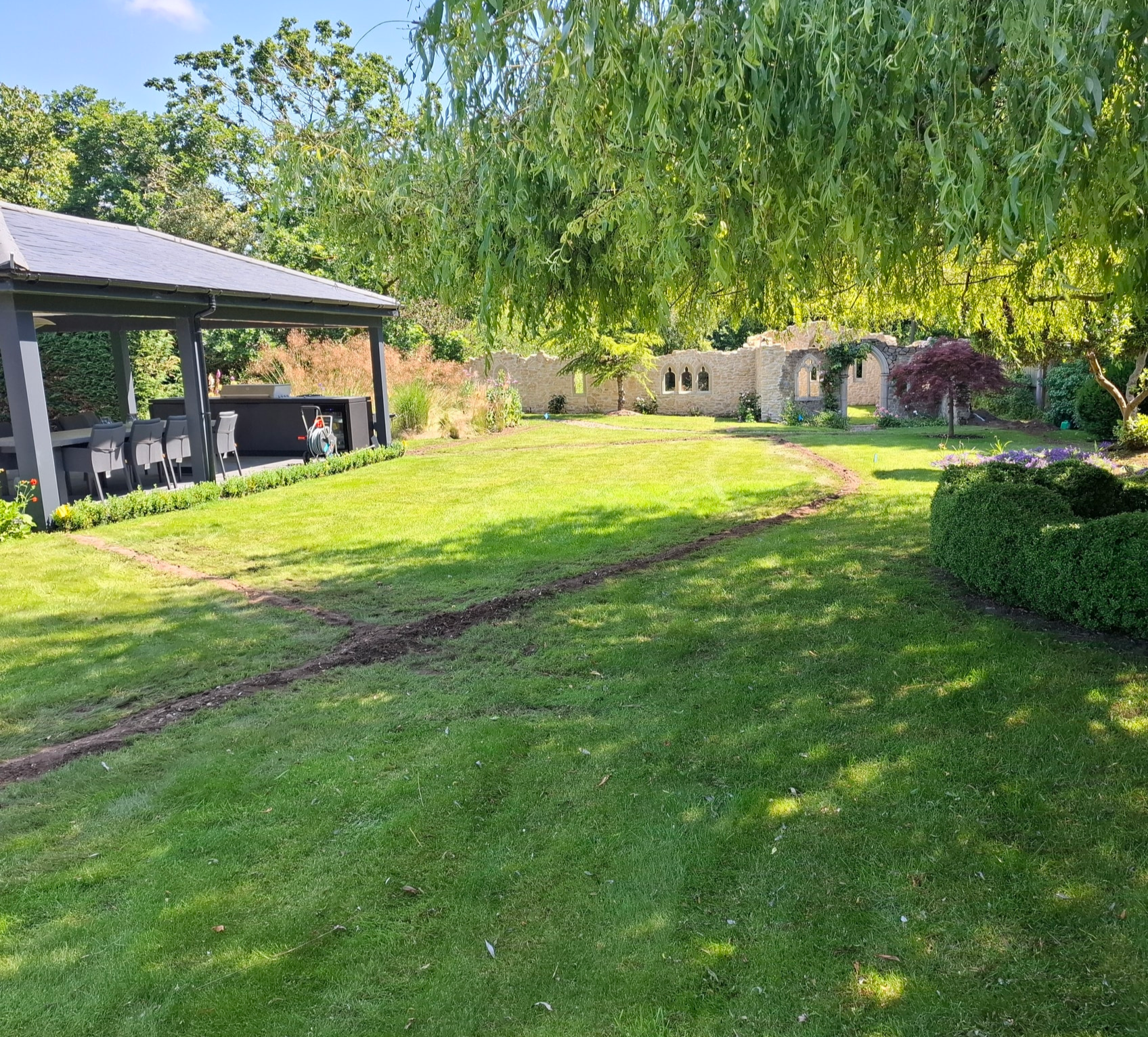 backfilled trench in  grass