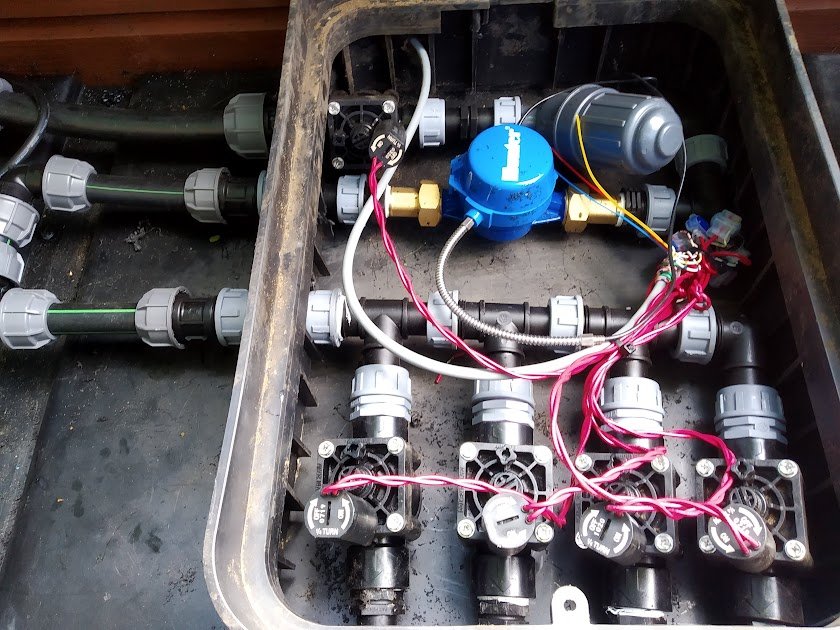 distribution unit with inline filter and flow sensor on top of the irrigation tank