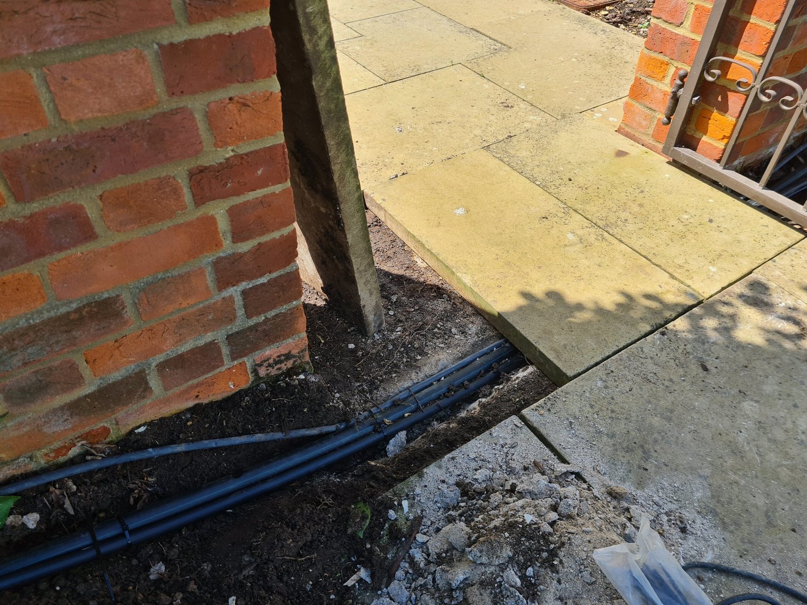 Laying pipes under paving